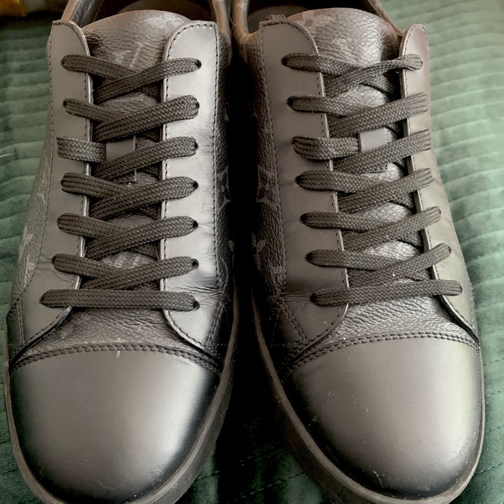 Sneakers by Louis Vuitton's Monogram Eclipse canvas and a black rubber sole.